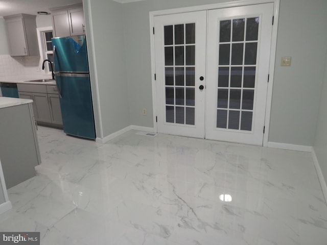 interior space featuring french doors, refrigerator, sink, gray cabinets, and black dishwasher