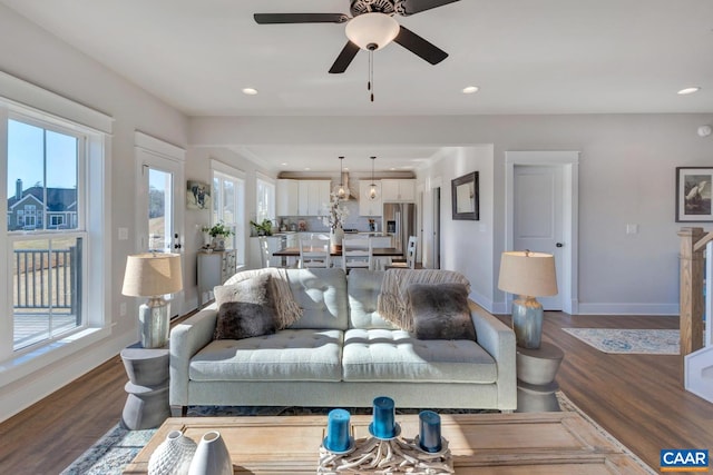 living room featuring hardwood / wood-style floors and ceiling fan