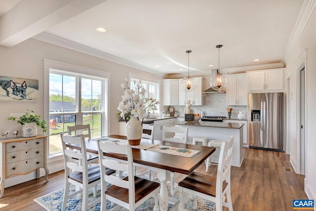 dining area featuring dark hardwood / wood-style floors, plenty of natural light, and ornamental molding