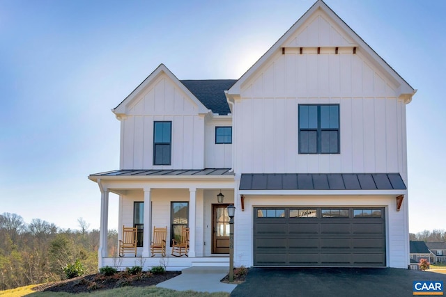 modern farmhouse with a garage and a porch