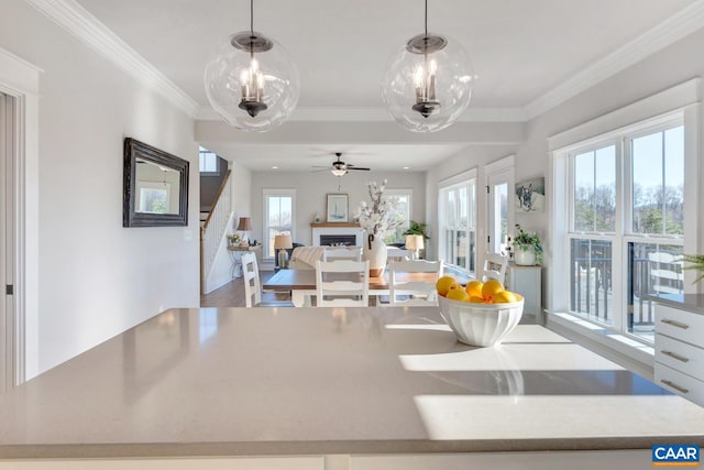 interior space featuring crown molding, hardwood / wood-style flooring, and decorative light fixtures