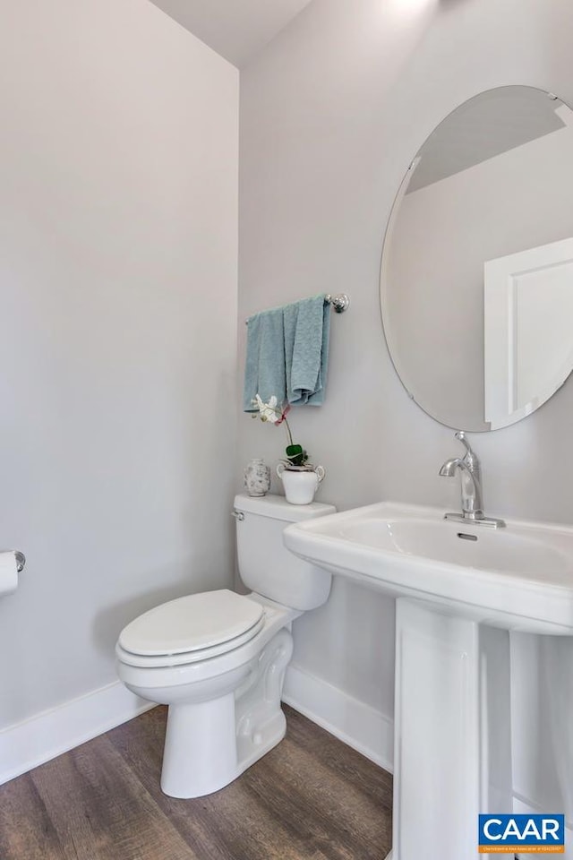 bathroom with hardwood / wood-style floors and toilet