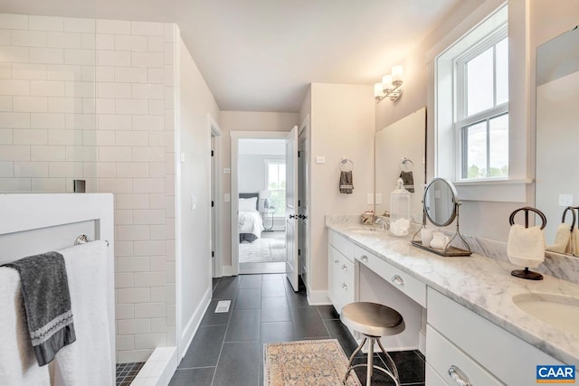 bathroom featuring vanity, a wealth of natural light, tile patterned floors, and tiled shower