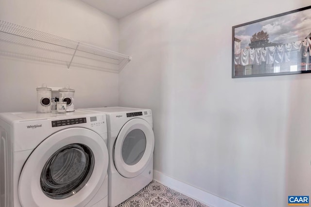 laundry room with light tile patterned flooring and washer and dryer