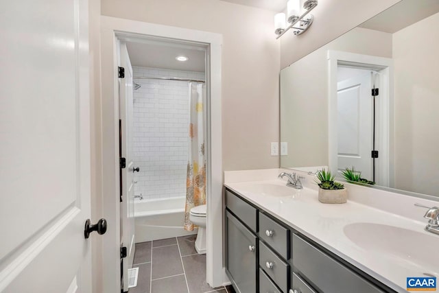 full bathroom with toilet, shower / tub combo, vanity, and tile patterned flooring