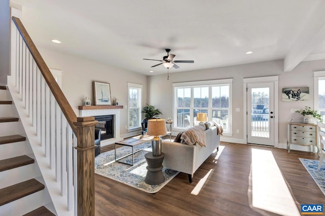 living room featuring hardwood / wood-style floors and ceiling fan