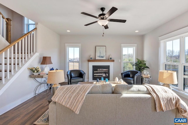 living room with ceiling fan, dark hardwood / wood-style floors, and a healthy amount of sunlight