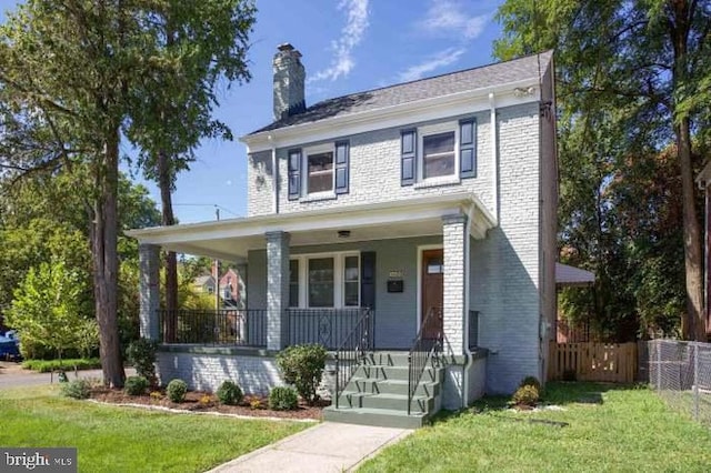 view of front of home with a front lawn and covered porch