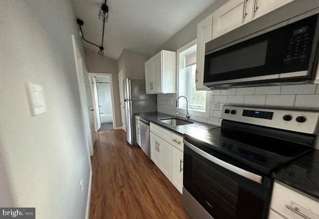 kitchen featuring sink, appliances with stainless steel finishes, dark hardwood / wood-style floors, backsplash, and white cabinets