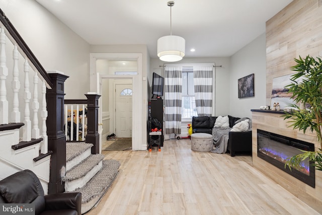 entrance foyer featuring a fireplace and light hardwood / wood-style floors