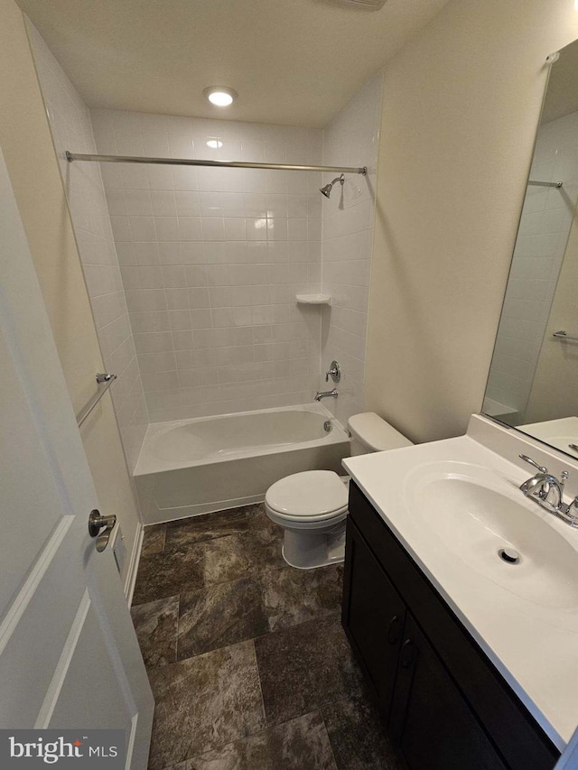 full bathroom featuring vanity, toilet, and tiled shower / bath