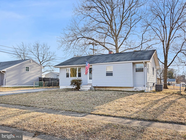 view of front of home featuring entry steps, central AC unit, a chimney, and fence