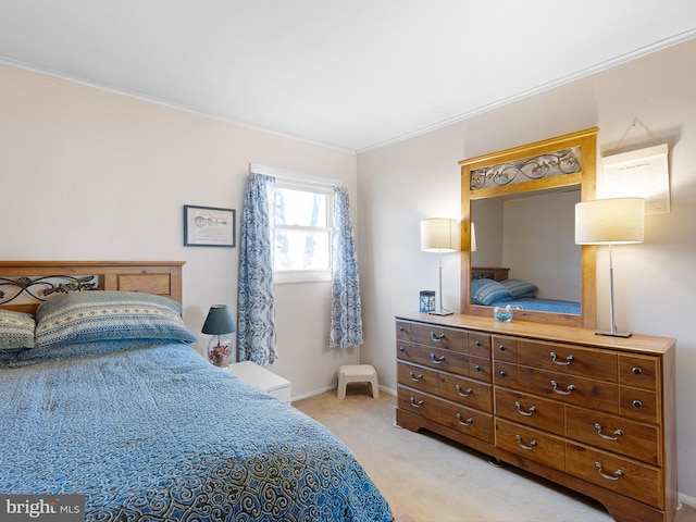 bedroom with ornamental molding, light colored carpet, and baseboards