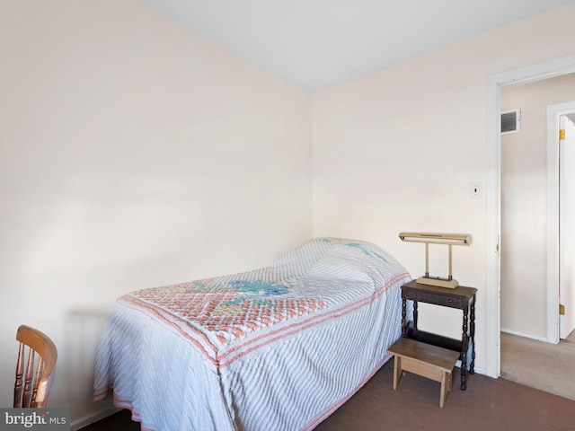 bedroom featuring carpet floors, visible vents, and baseboards