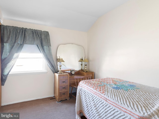 bedroom featuring lofted ceiling, carpet flooring, and baseboards