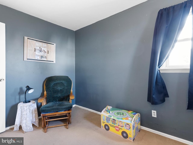 sitting room with carpet and baseboards