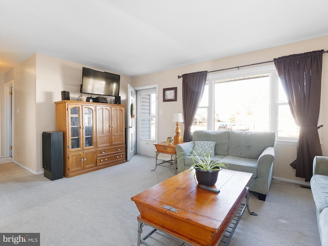 living room with light carpet and baseboards