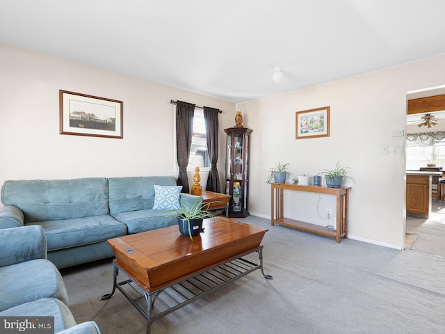 living room featuring light carpet and baseboards