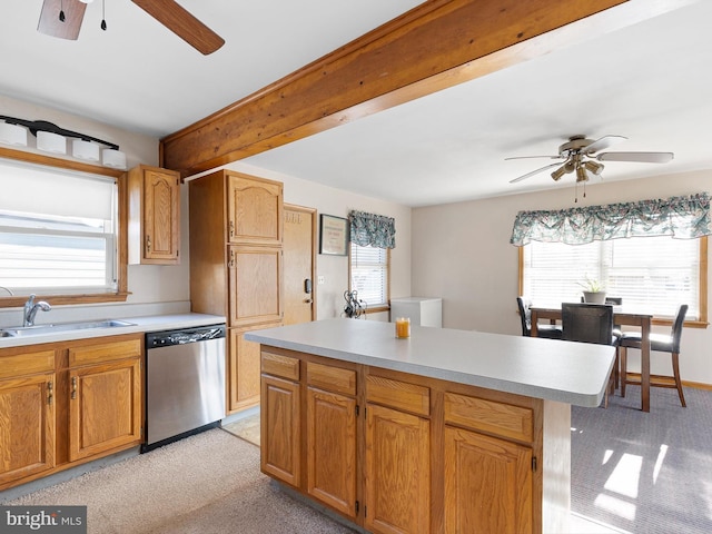 kitchen with a healthy amount of sunlight, light countertops, dishwasher, and a sink