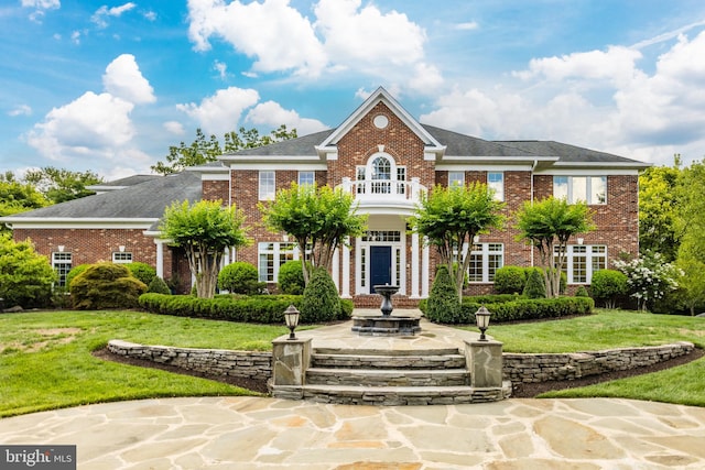 colonial home with a front lawn