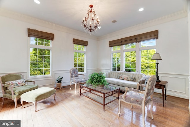 6318 Georgetown Pike, Mclean, VA 22101 - living area with wood-type flooring, a decorative wall, crown molding, wainscoting, and a chandelier