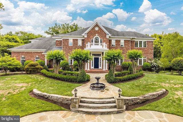 6318 Georgetown Pike, Mclean, VA 22101 - colonial-style house featuring brick siding, a front yard, and a shingled roof