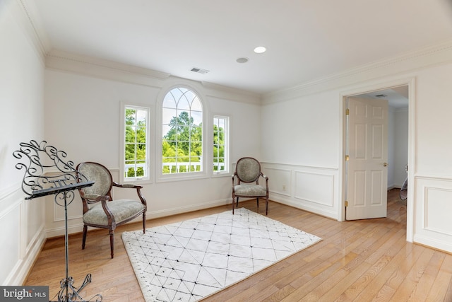 6318 Georgetown Pike, Mclean, VA 22101 - sitting room with ornamental molding, light wood-type flooring, a decorative wall, and a wainscoted wall