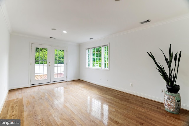 unfurnished room with french doors, light wood-type flooring, and ornamental molding