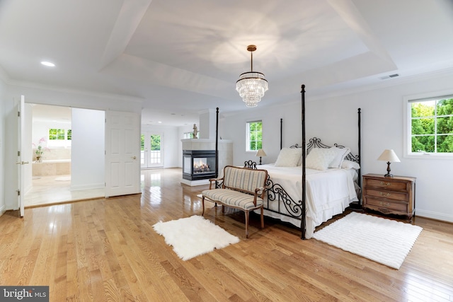 6318 Georgetown Pike, Mclean, VA 22101 - bedroom featuring multiple windows, a chandelier, light wood-style floors, a tray ceiling, and crown molding