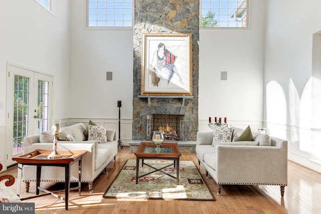 6318 Georgetown Pike, Mclean, VA 22101 - living room featuring a high ceiling, a fireplace, healthy amount of natural light, wainscoting, and wood finished floors