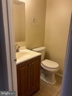 bathroom with tile patterned floors, vanity, and toilet