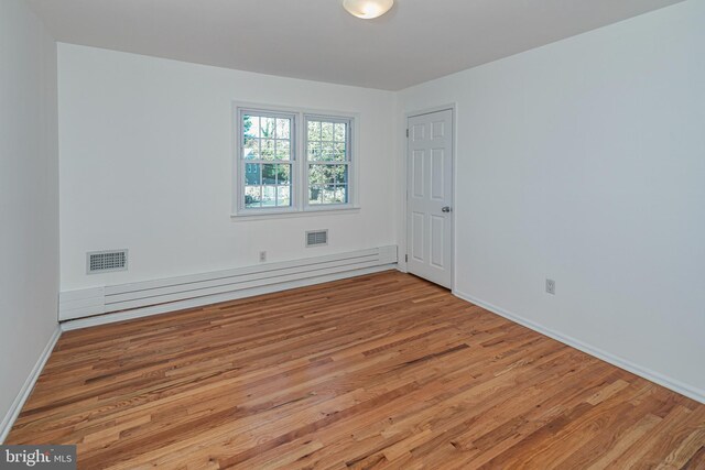 339 Hamilton Ave, Princeton, NJ 08540 - spare room with baseboard heating, wood finished floors, and baseboards