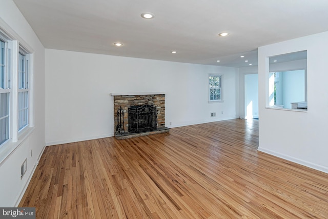 339 Hamilton Ave, Princeton, NJ 08540 - unfurnished living room with light wood-style flooring, a stone fireplace, recessed lighting, and baseboards