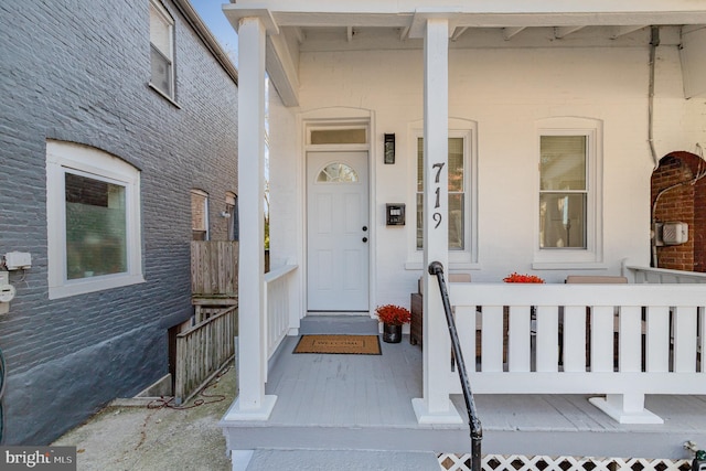 view of exterior entry featuring a porch