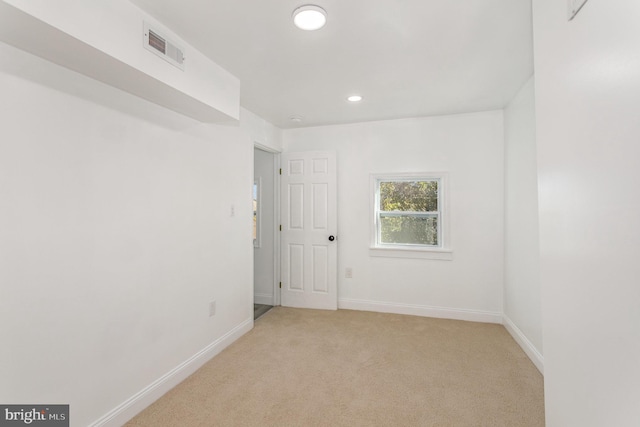 empty room featuring light carpet