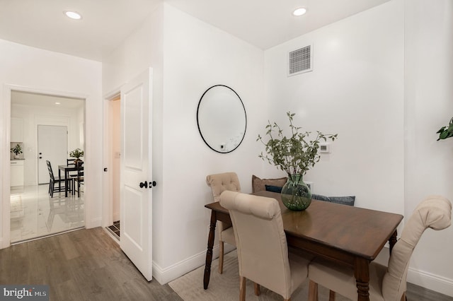 dining room with wood-type flooring