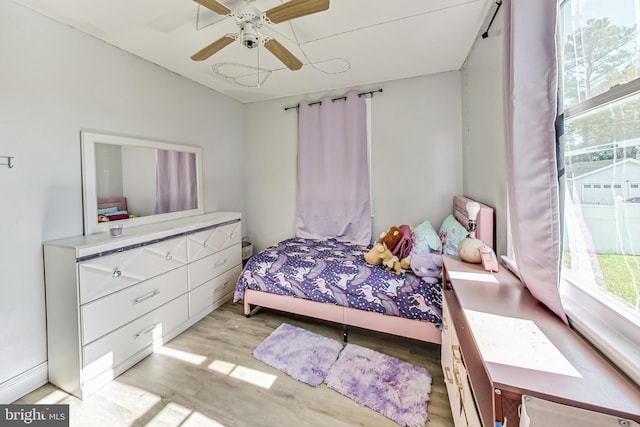 bedroom with ceiling fan and light hardwood / wood-style flooring