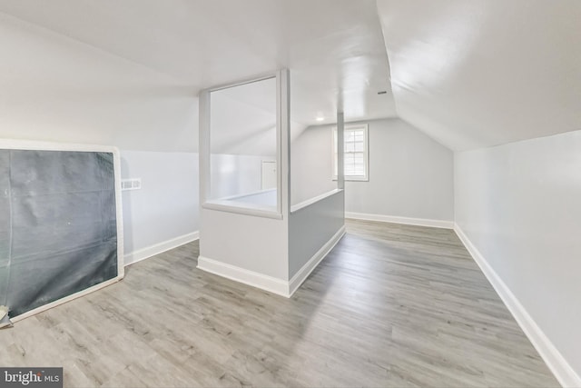 bonus room featuring hardwood / wood-style floors and vaulted ceiling