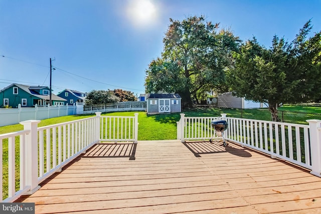 deck with a yard and a storage unit