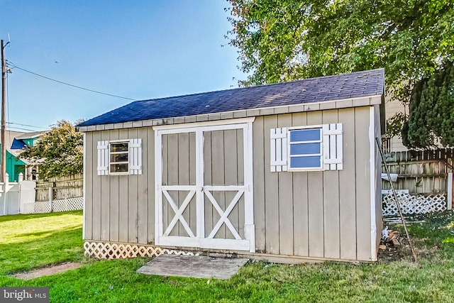 view of outbuilding featuring a lawn