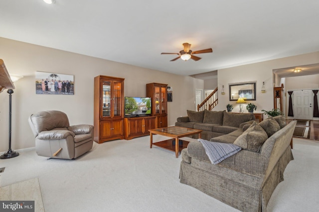 carpeted living room featuring ceiling fan