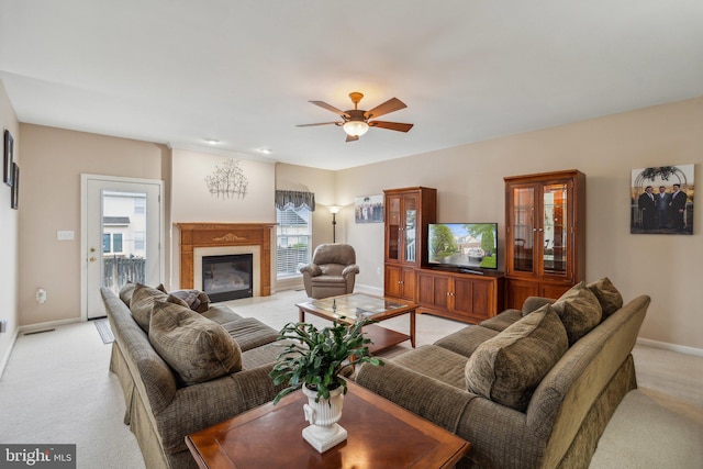 carpeted living room with ceiling fan