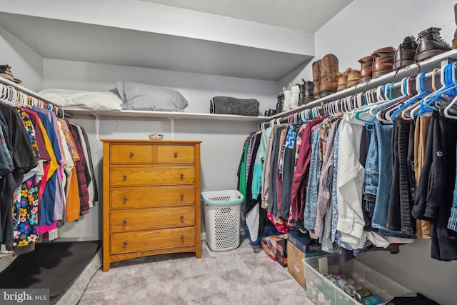 walk in closet featuring light carpet