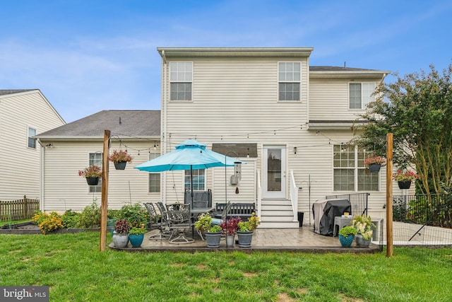 rear view of property featuring a yard and a patio area