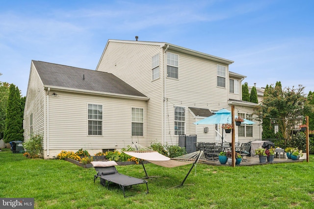 rear view of house featuring a patio and a yard