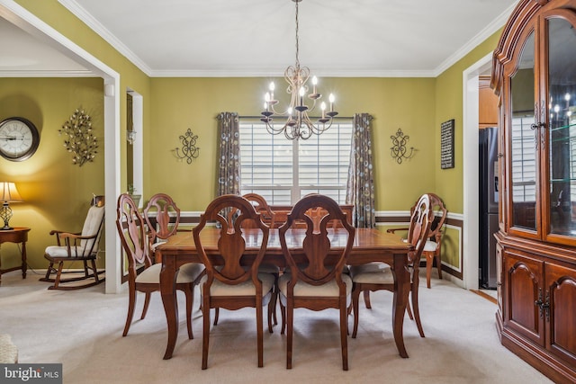 carpeted dining space featuring a chandelier and crown molding