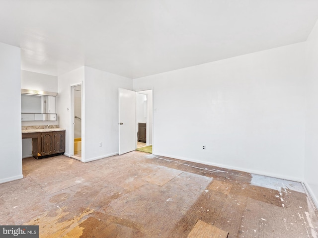 unfurnished bedroom with ensuite bath and sink