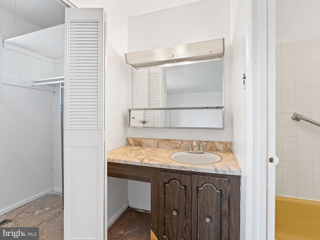 bathroom featuring vanity and a tub