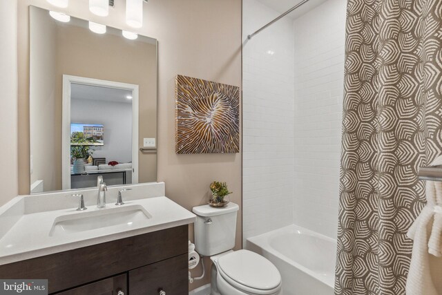 full bathroom with vanity, toilet, and tiled shower / bath combo