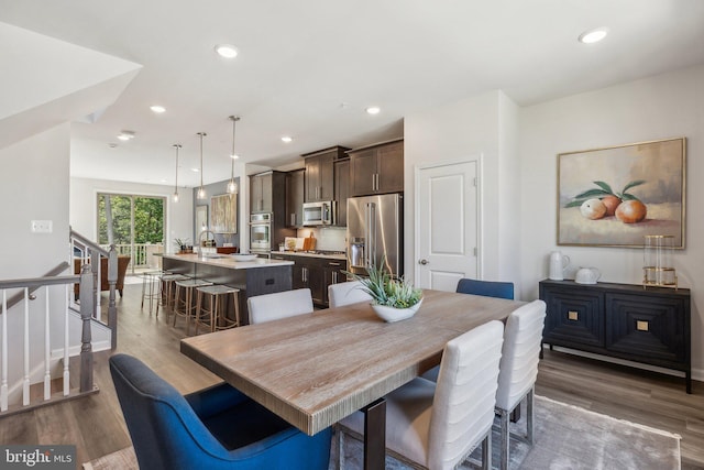 dining space with dark hardwood / wood-style flooring and sink